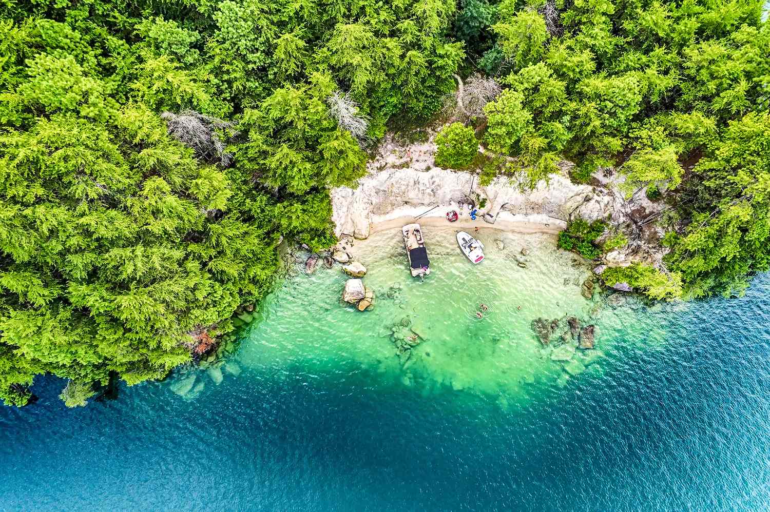 Ariel view of clear blue waters that look like the Caribbean but is actually on Lake Jocassee, South Carolina. 