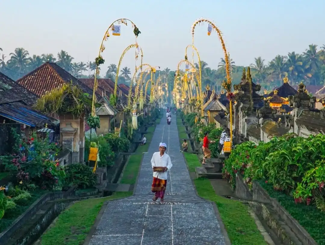 Local villager walking down a small street in Penglipuran, Bali.