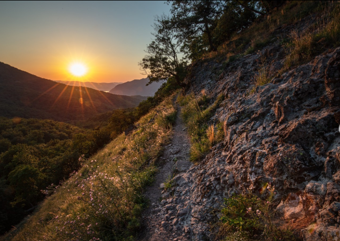 Rocky trail on the side of a mountain at sunset on Spartacus Trail in Hungary.