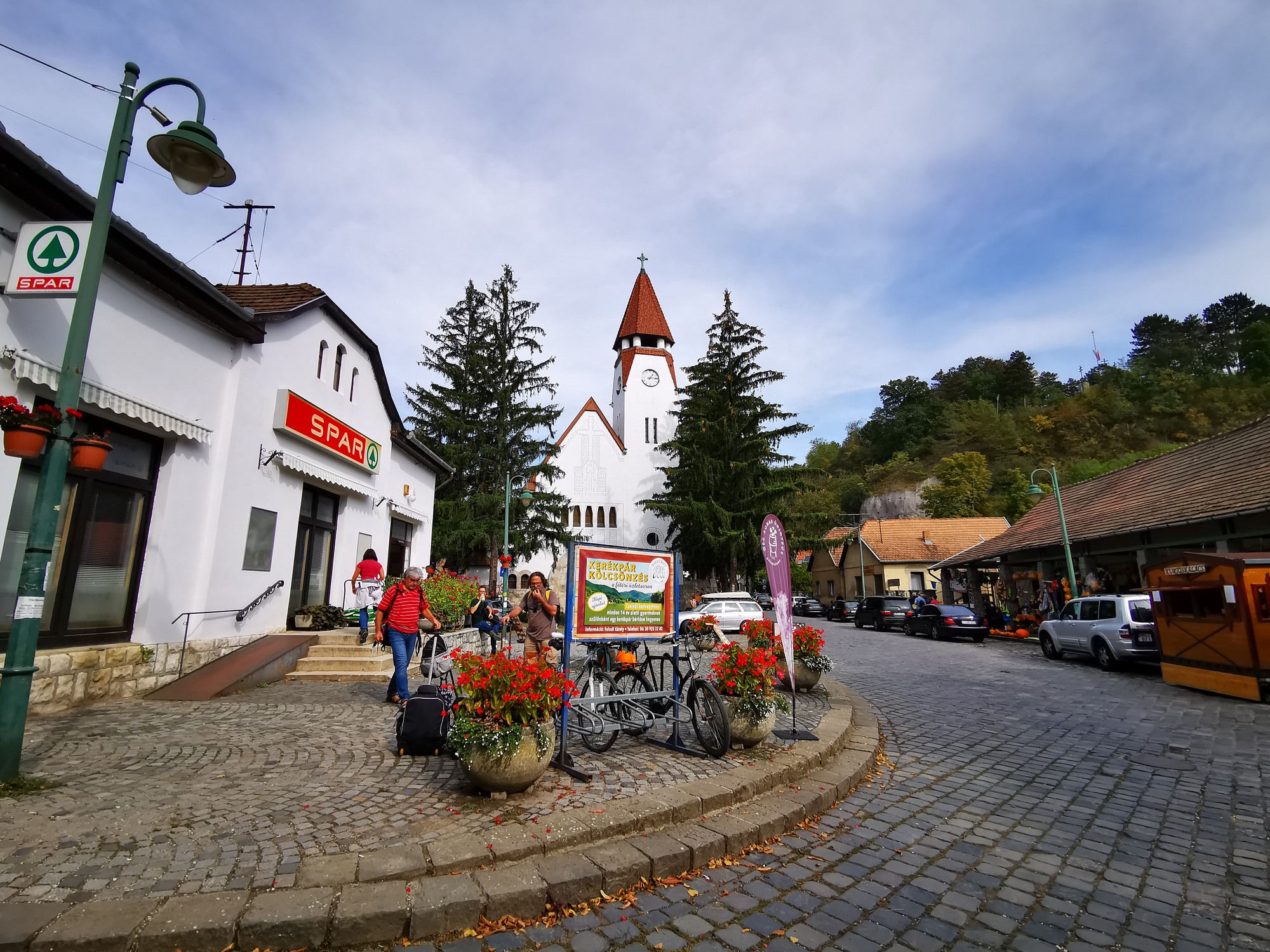Zebegény village with Cobblestone streets and visitors walking around.