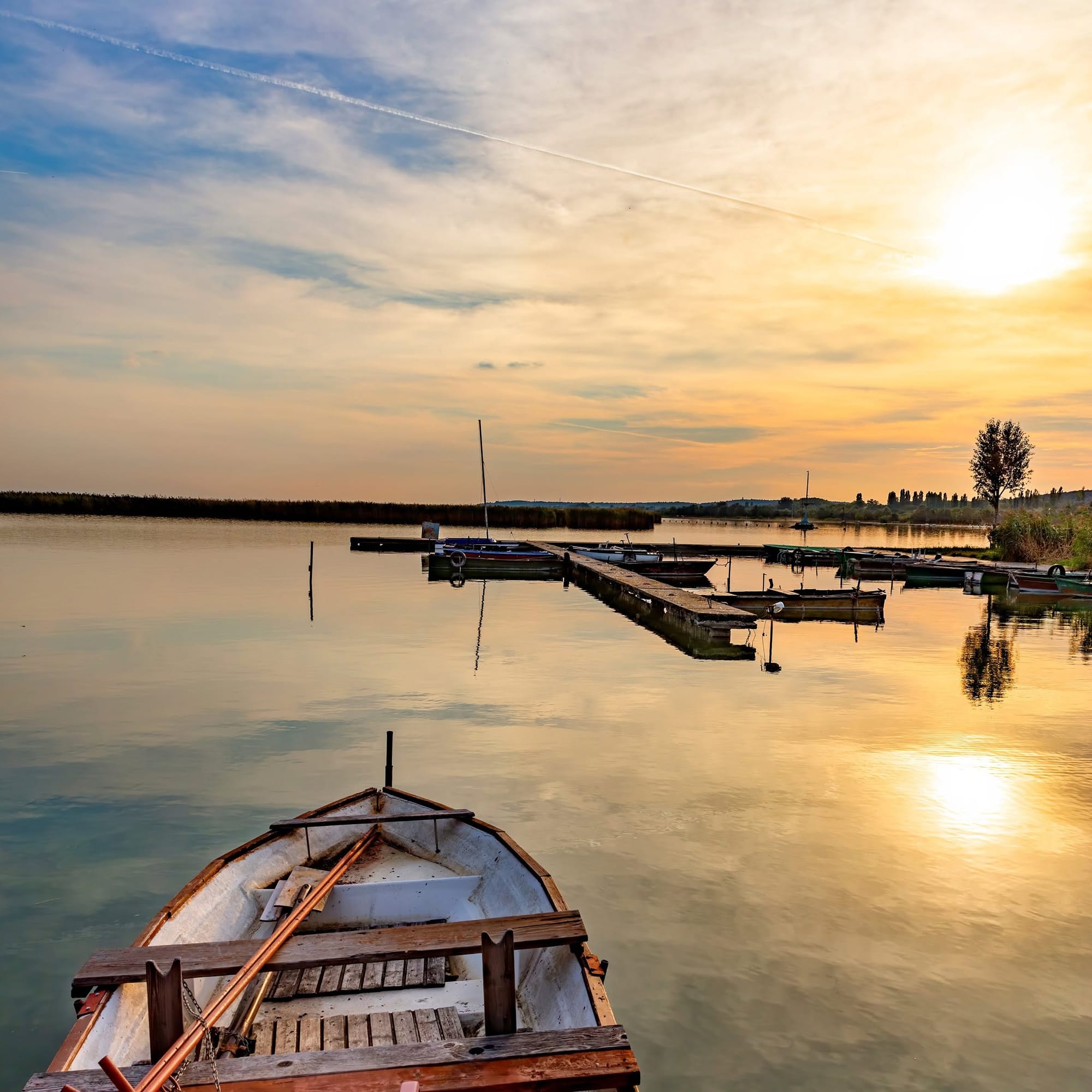 A small boat floating in Lake Velence In Hungary