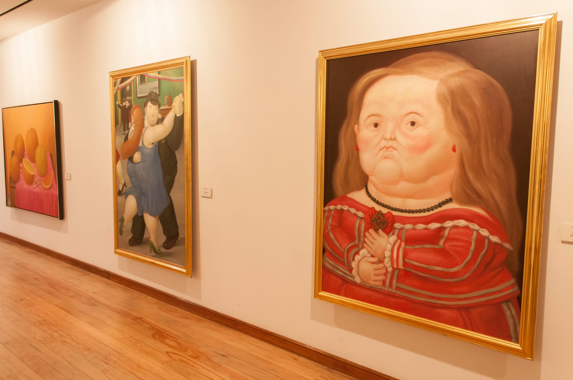 Paintings of obese people inside the Botero Museum in Bogota.
