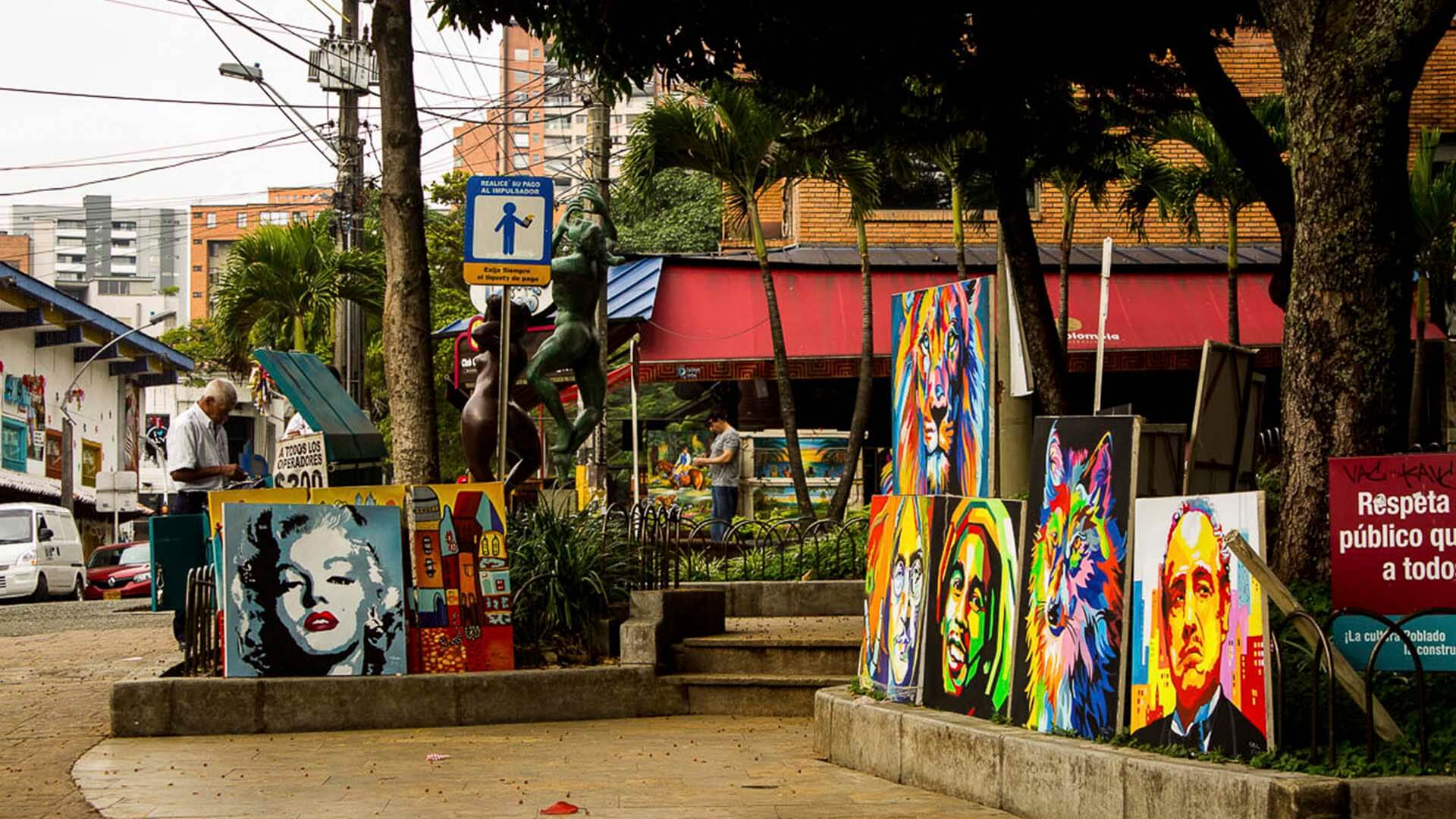 El Poblado artwork for sale on the side of the street.
