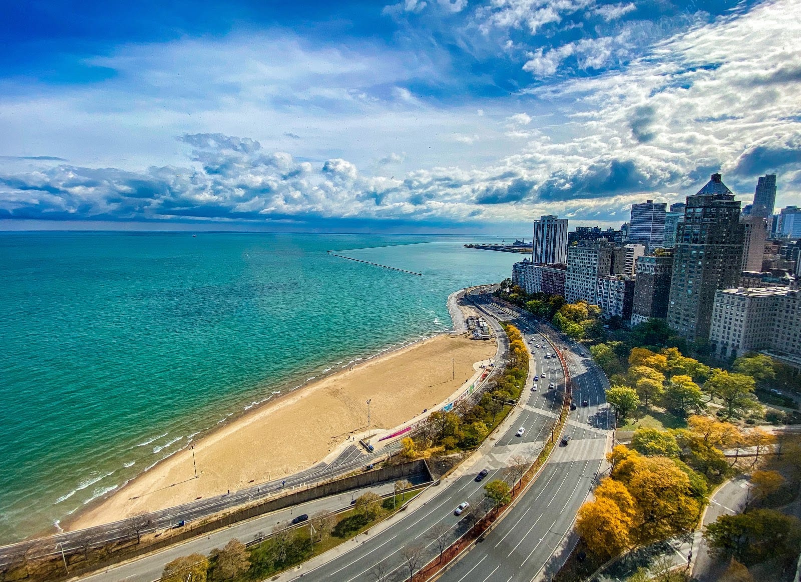 Oak Street Beach ariel view with large Chicago city building seen in the background.