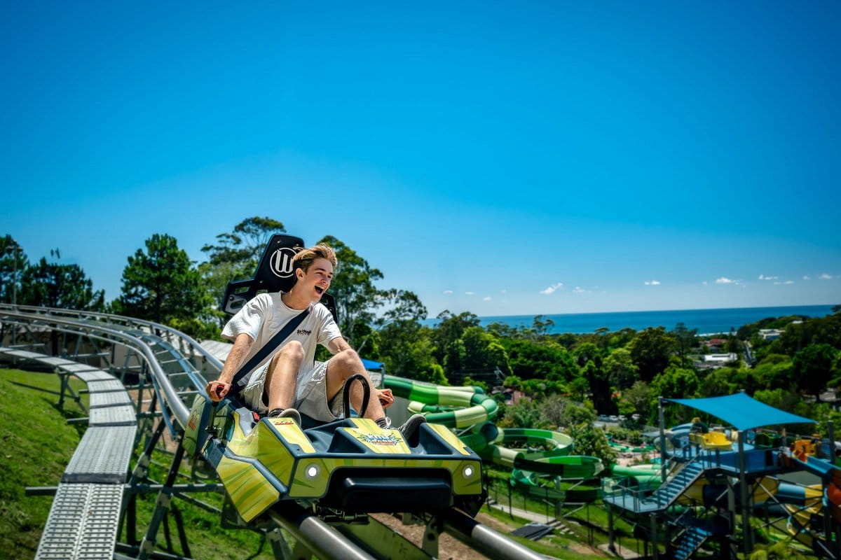 Guy riding a solo ride roller coaster in Coffs Harbour, Australia at The Big Banana Fun Park