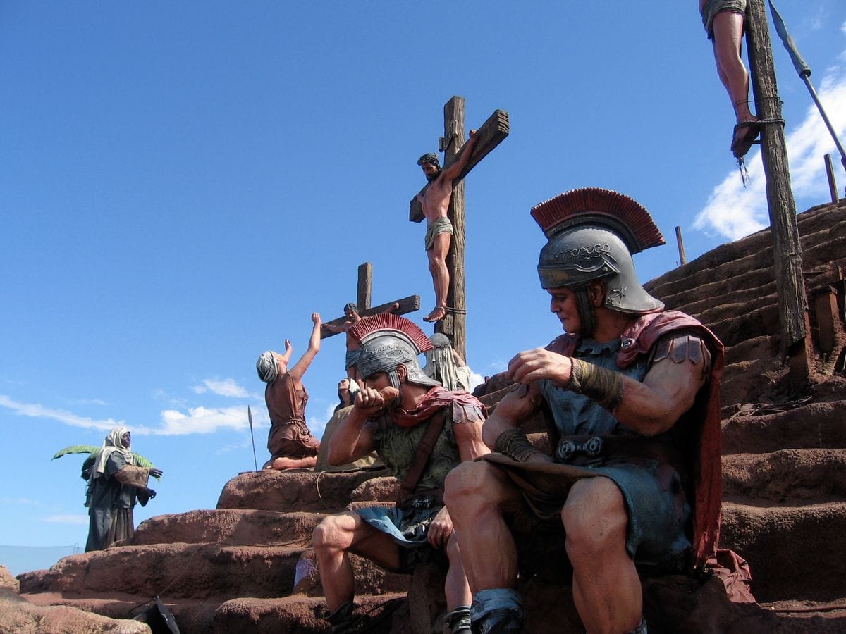 Roman Guards beside people being crucified during a biblical reenactment.