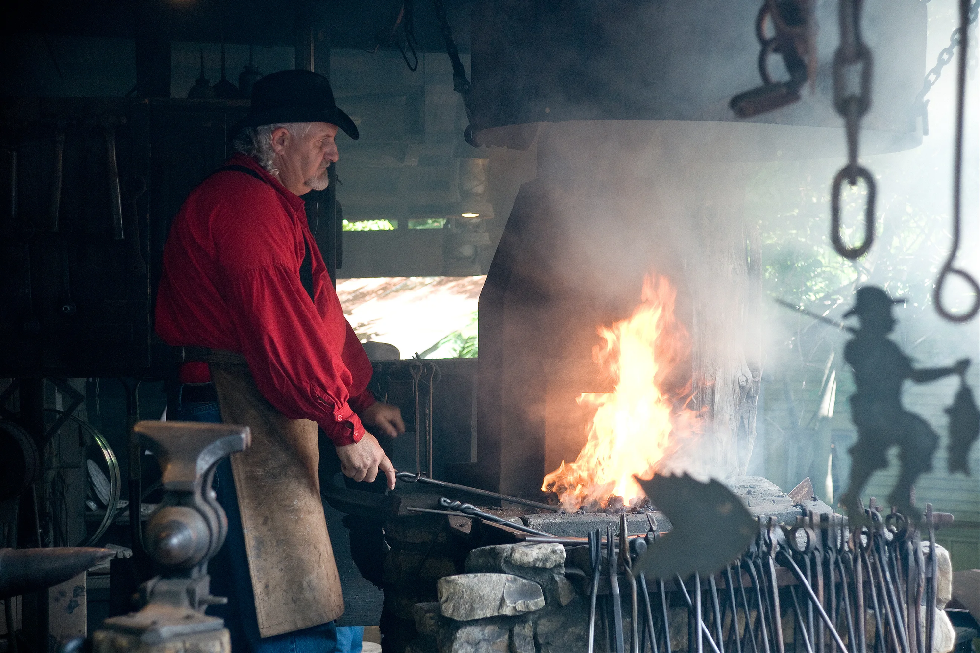 Blacksmith with a fire and 1800's style decor inside Silver Dollar City.