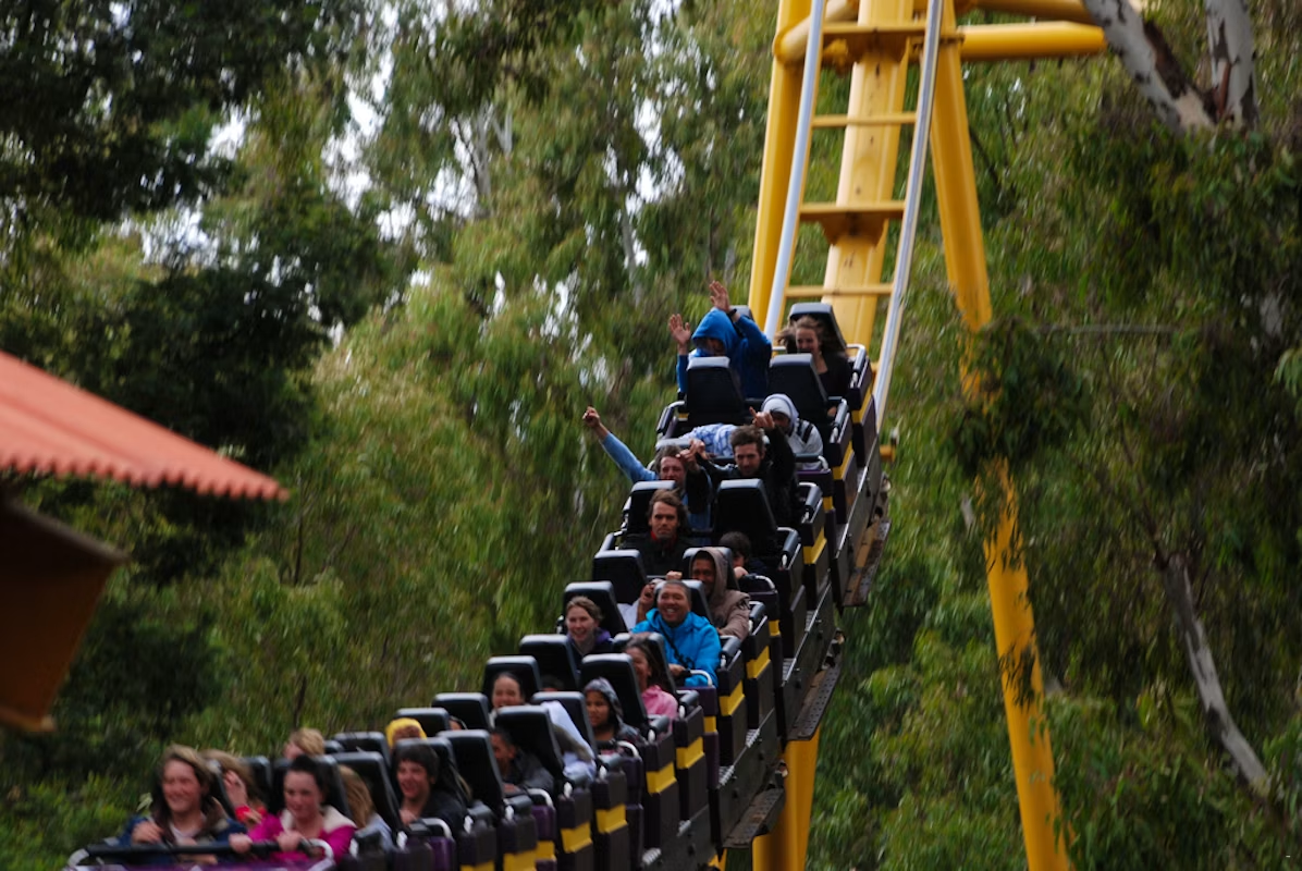 People coming down a roller coaster inside Gold Reef City Amusement park.