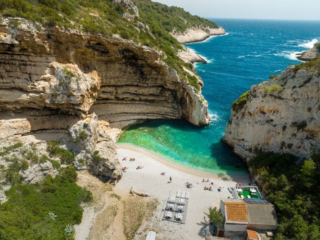 Stiniva Beach in Croatia surrounded by cliffs.