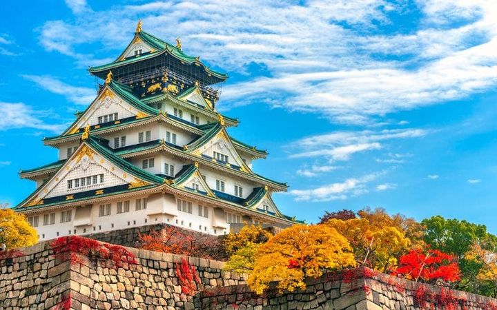 Osaka Castle Temple during the fall, with tree that have autumn colors. 