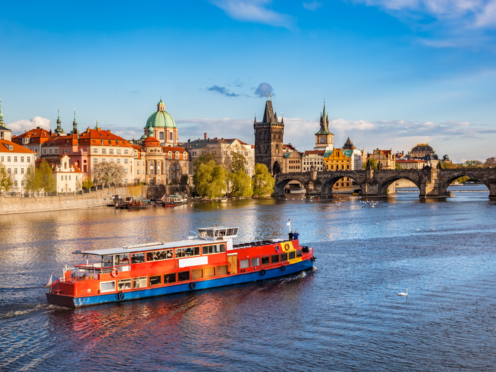 A boat on the river in Prague, Czech Republic about to pass under St. Charles bridge.