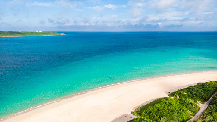 Ariel view of a beautiful Japanese beach with calm clear blue waters.