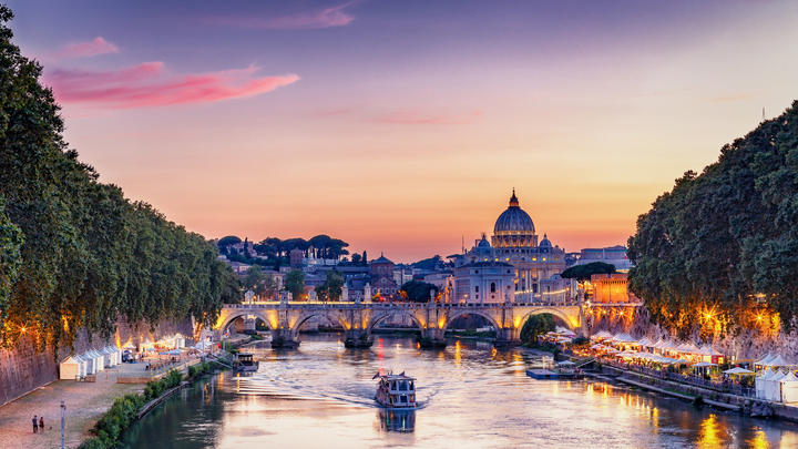 Boat tour with visitors on the river in Rome, Italy.