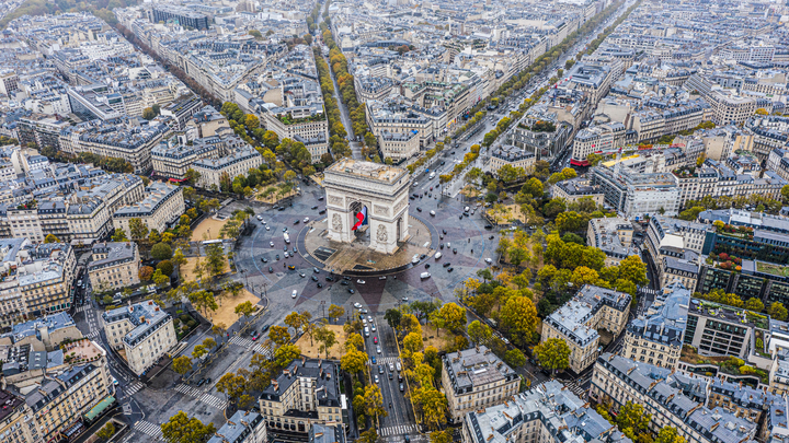 Ariel view of Arc de triomphe at top of Ave. Champs-Élysées in Paris, France.