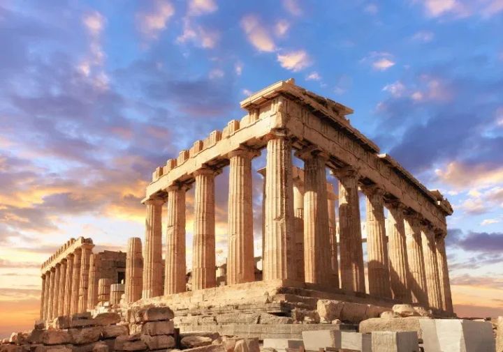 Acropolis in Athens, Greece at sunset is an ancient ruins with massive columns. 