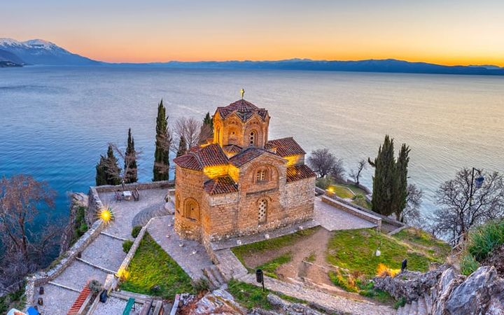 Sunset view of the Church of St. John at Kaneo perched on a cliff overlooking Lake Ohrid in North Macedonia.