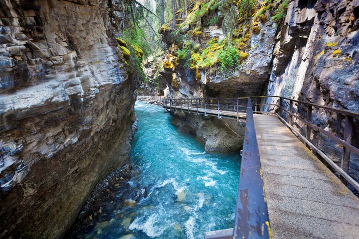 Johnson Canyon has swift turquois waters with a pedestrian walkway inside Banff National Park.