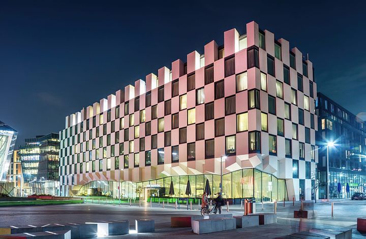 A Luxury Modern Hotel that is white in color at night time in Dublin, Ireland - Anantara The Marker Dublin 