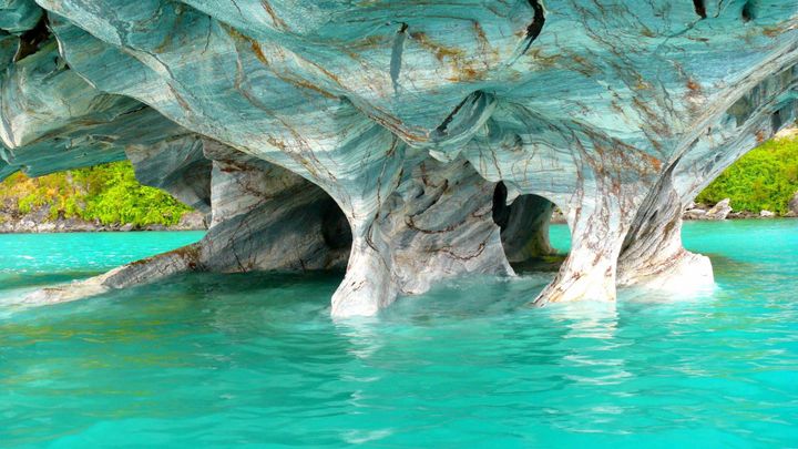 Marble Caves in Patagonia, Chile, with turquoise water reflecting smooth, swirling blue and white rock formations.