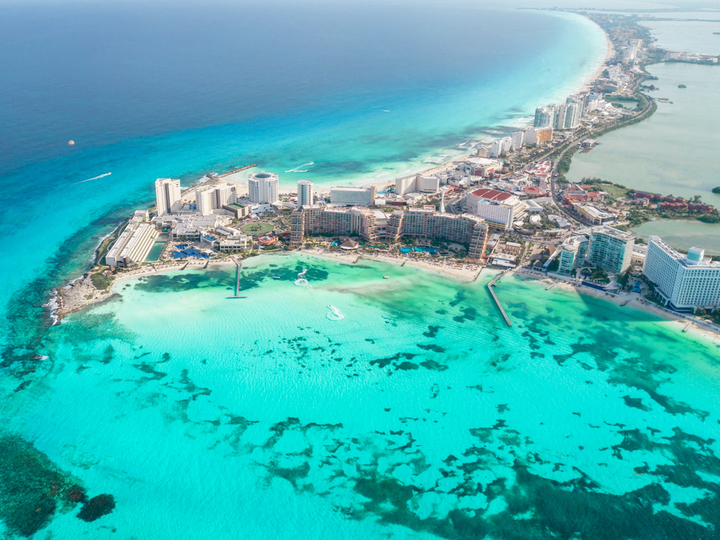 Ariel view of beautiful clear blue waters and beaches in Cancun's hotel zone.