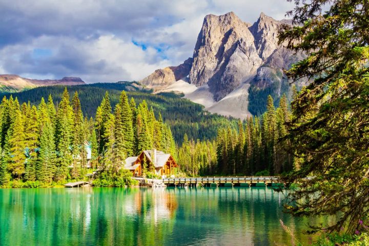 A beautiful lake with a cabin and mountain views in Canada. 