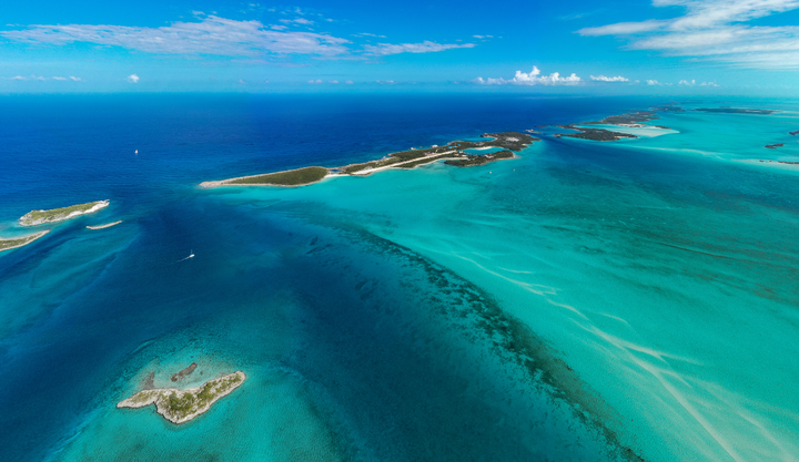 Ariel view of The Bahamas Exuma Cays with beautiful clear blue waters and thin strips of islands.