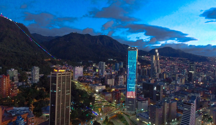 Ariel view of Bogota city with a view of the mountains at dusk. 