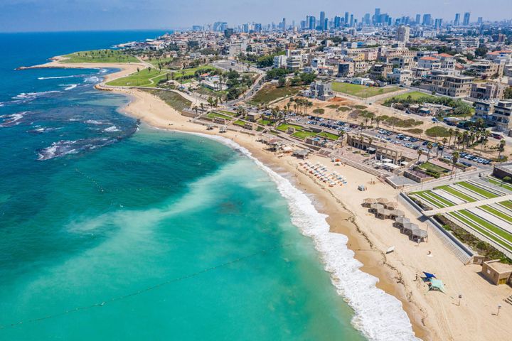 Ariel view of clear turquois waters of Gordon beach with a view of Tel Aviv, Israel.