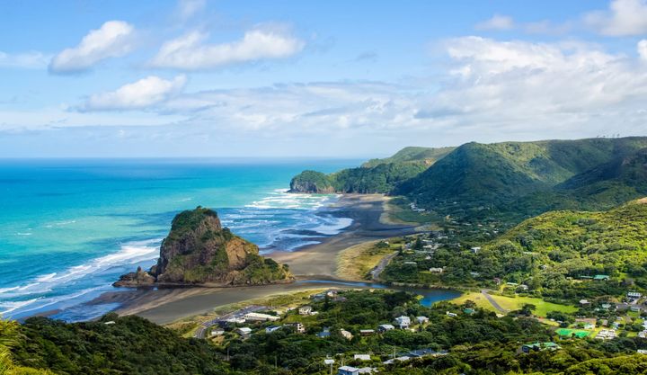 View of the beach and mountains at Piha beach in New Zealand.