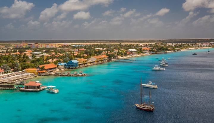 Many boats anchored off the shore in clear blue waters of Kralendijk, Bonaire.