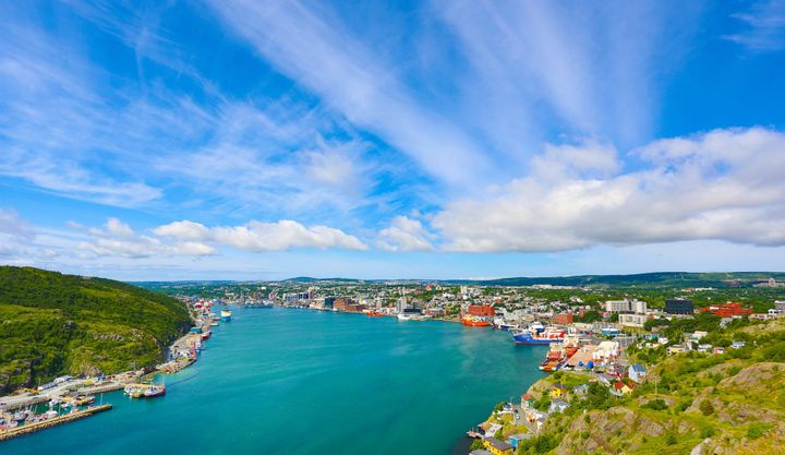 St. John's Harbor on a summer day and partly cloudy skies. 