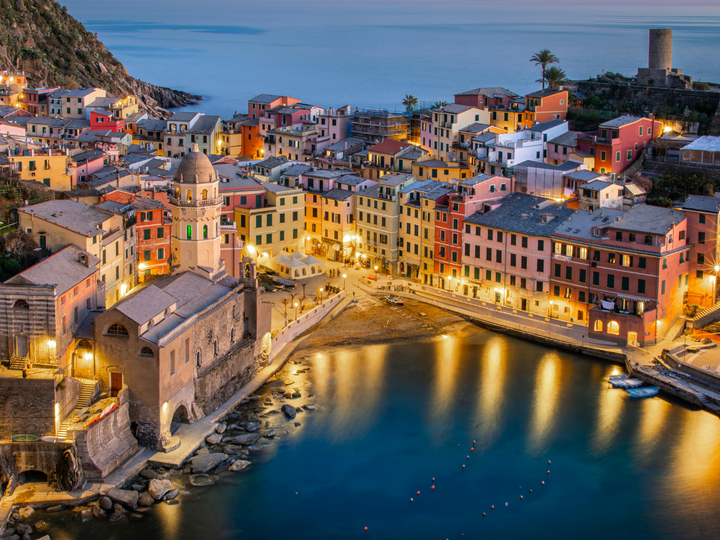 Genoa Italy at night with ocean views.