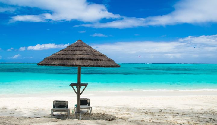 Grace bay beach turks and caicos on a partly cloudy day.
