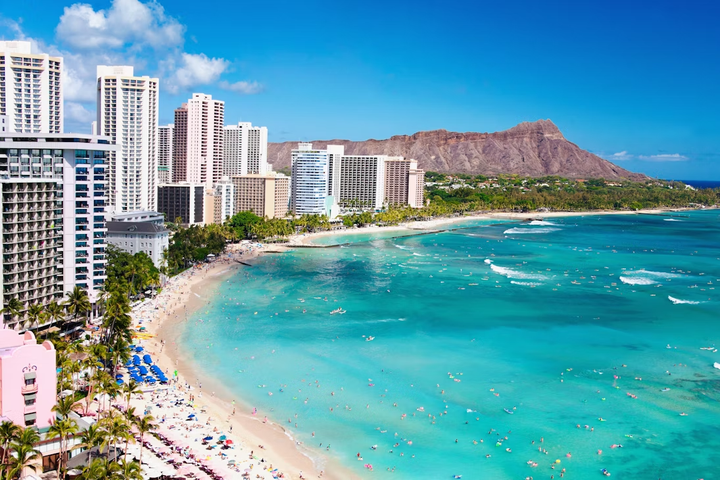 People playing and swimming at Waikiki Beach in Honolulu, Hawaii