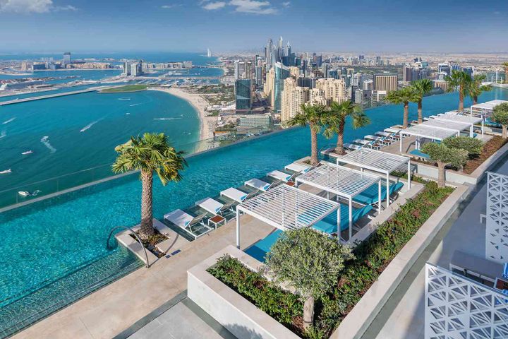 A roof top pool at a resort in Dubai, over looking the ocean.