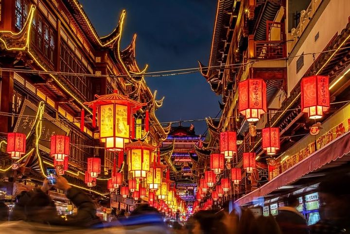 Red lantors lit up at night on the streets of Shanghai, China.