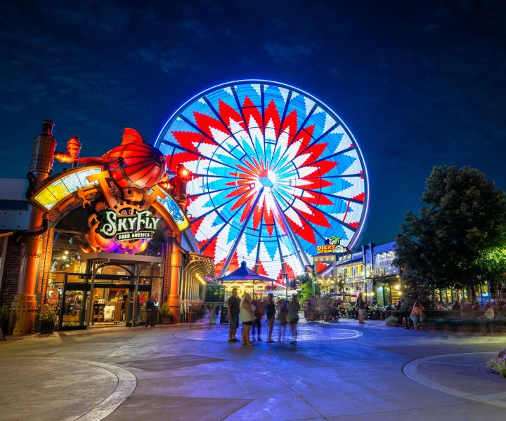 A farris wheel lit up at night in Pigeon Forge Tennessee - SkyFly Soar America 