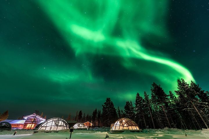Tents under the Northern Lights in the Snowy Finish Countryside of Lapland.