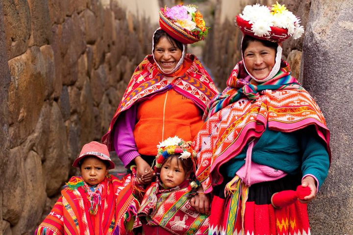 Native woman and children wearing bright colors in Peru.