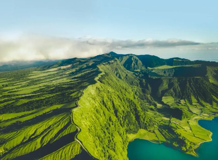 Azores Islands ariel view of lush green mountains overlooking the ocean.