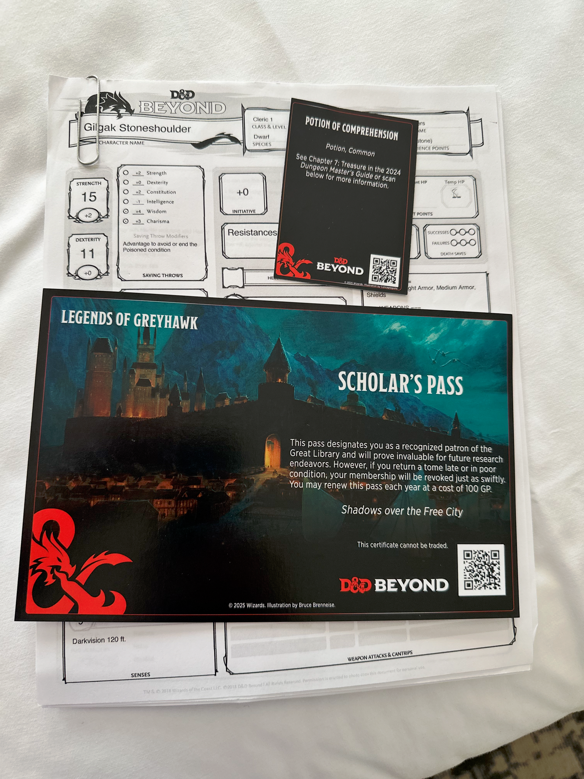 A D&D character sheet and a card saying "Potion of Comprehension" and a postcard-sized handout saying "Scholar's Pass."