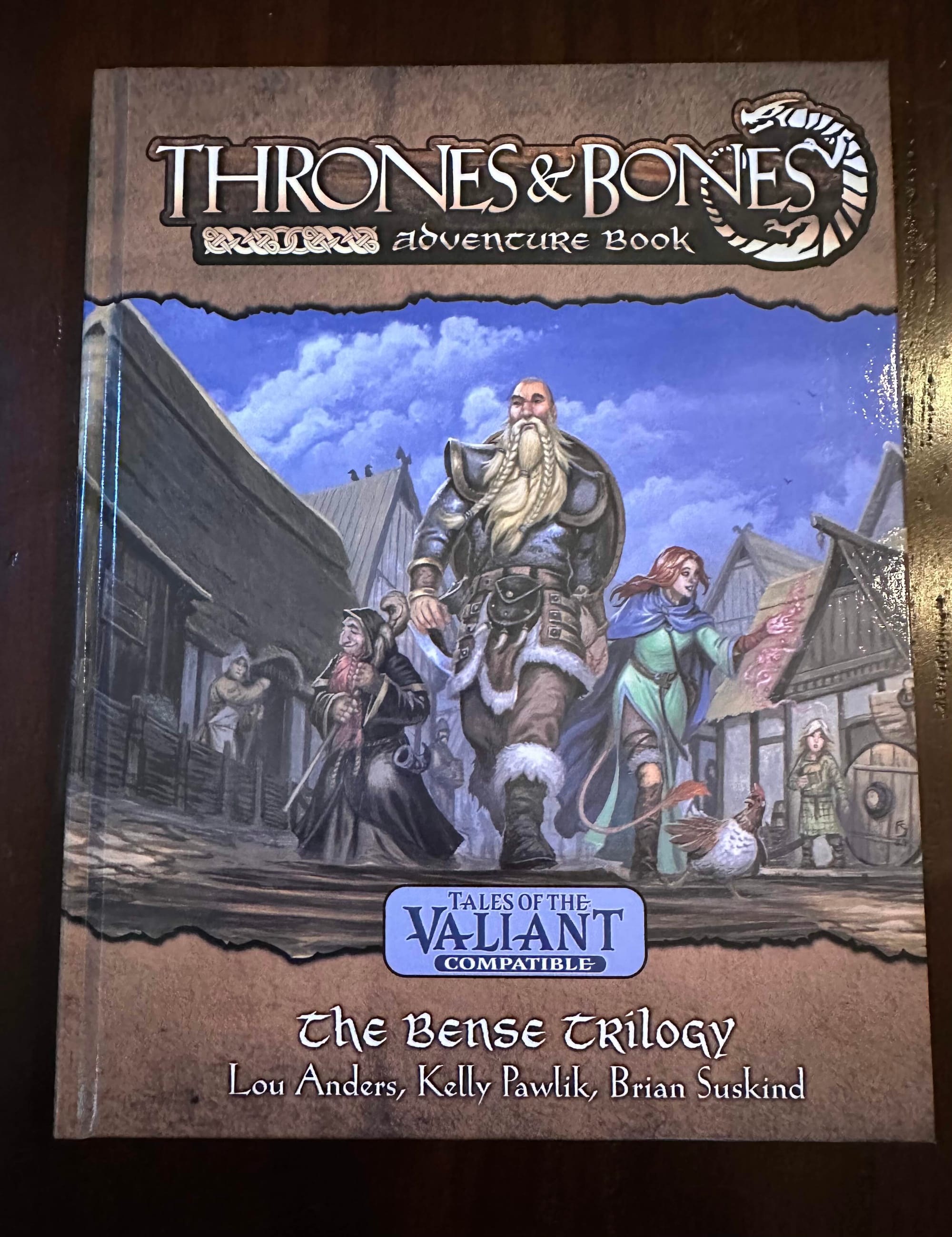 Three Nordic heroes stride through a Norse-style town