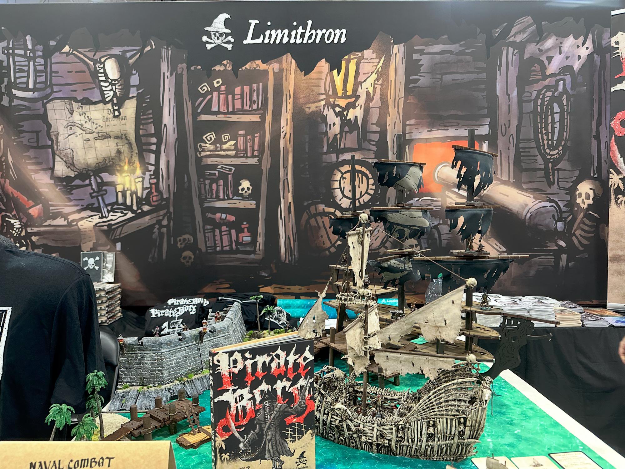 Limithron's booth for Pirate Borg with a display with a pirate ship and coastal fort