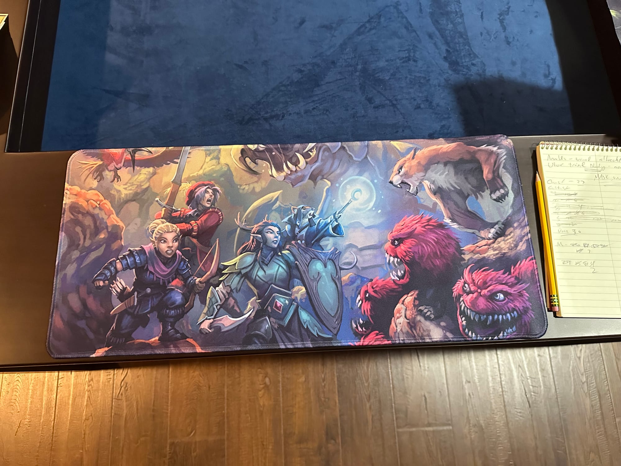 Four heroes fighting a variety of monsters on a custom playmat
