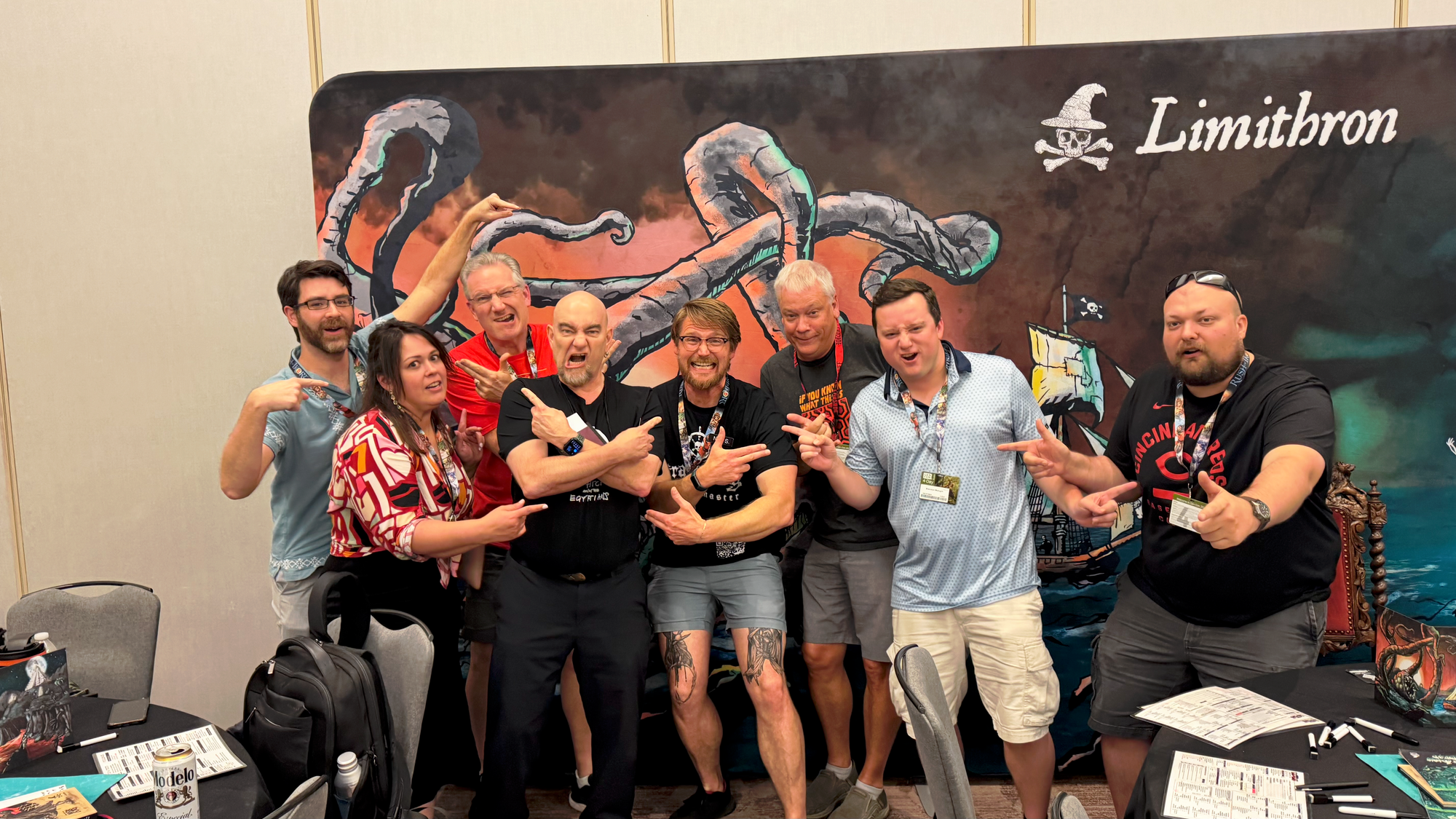 eight folks in front of a pirate borg banner pointing and making pirate faces