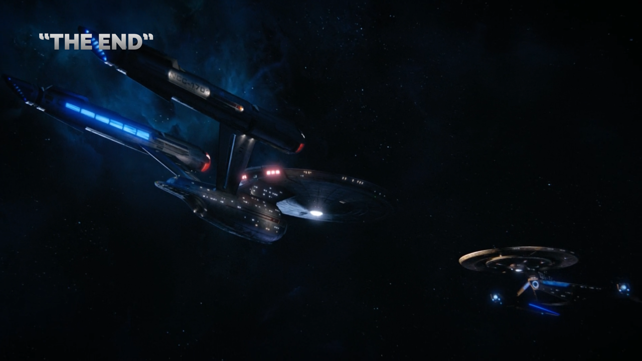 We see an aft view of the starship Enterprise as it appeared in Star Trek: Discovery, slightly different from its original appearance and more grey than grey-white, but still with the familiar saucer section, attached cylindrical engineering section, and twin cylindrical warp nacelles.