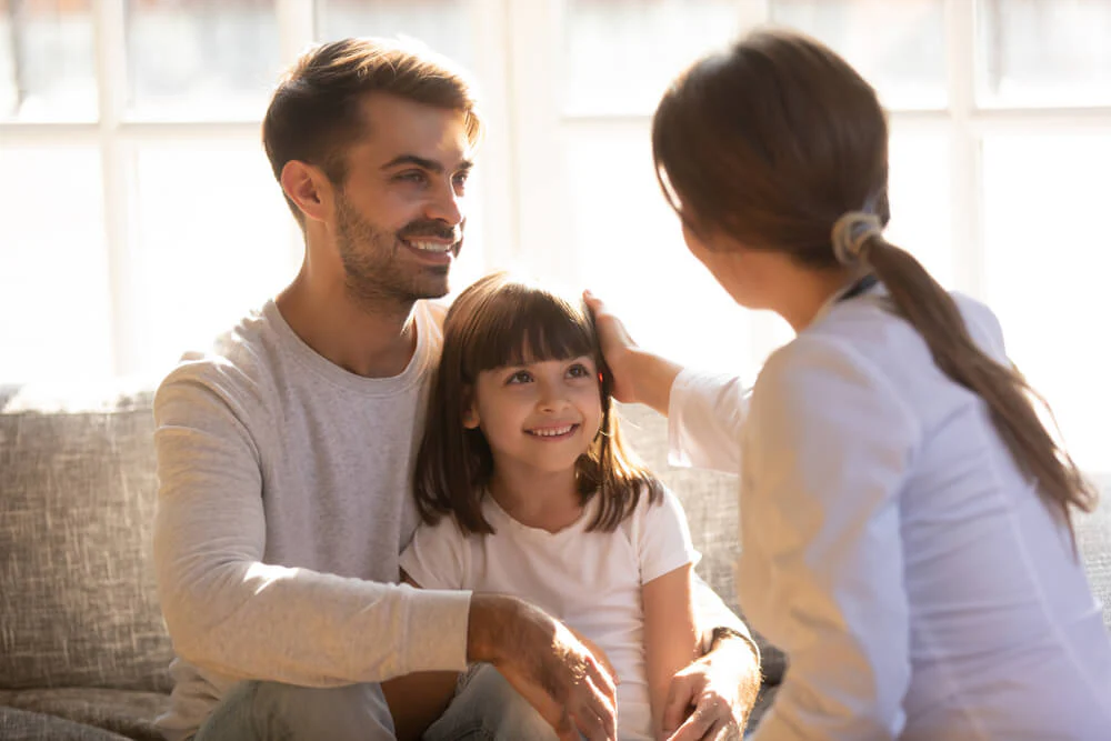 Parents patting on child - Parenting Hell