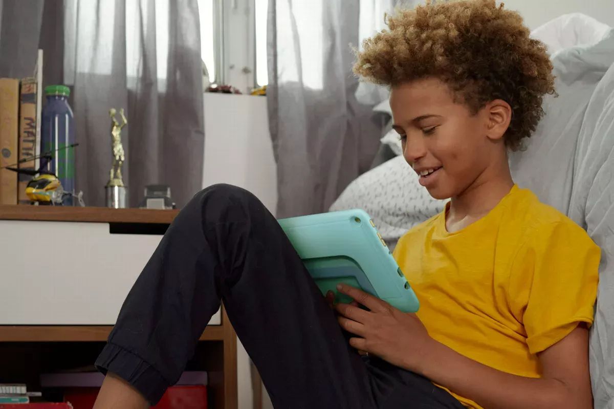 Boy leaning against couch - Best Drawing Apps for Kids