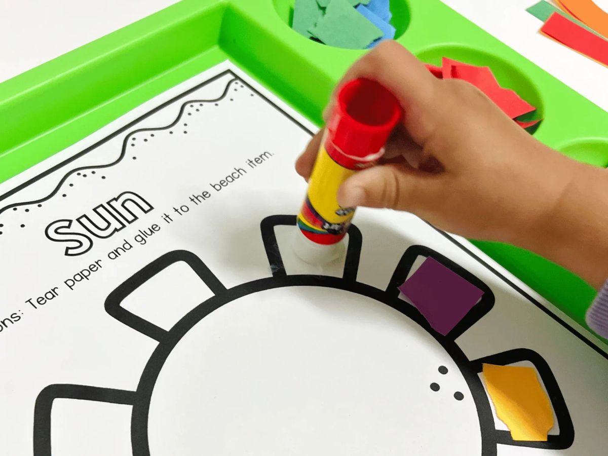 boy using glue - Fun and Easy Fall Preschool Crafts