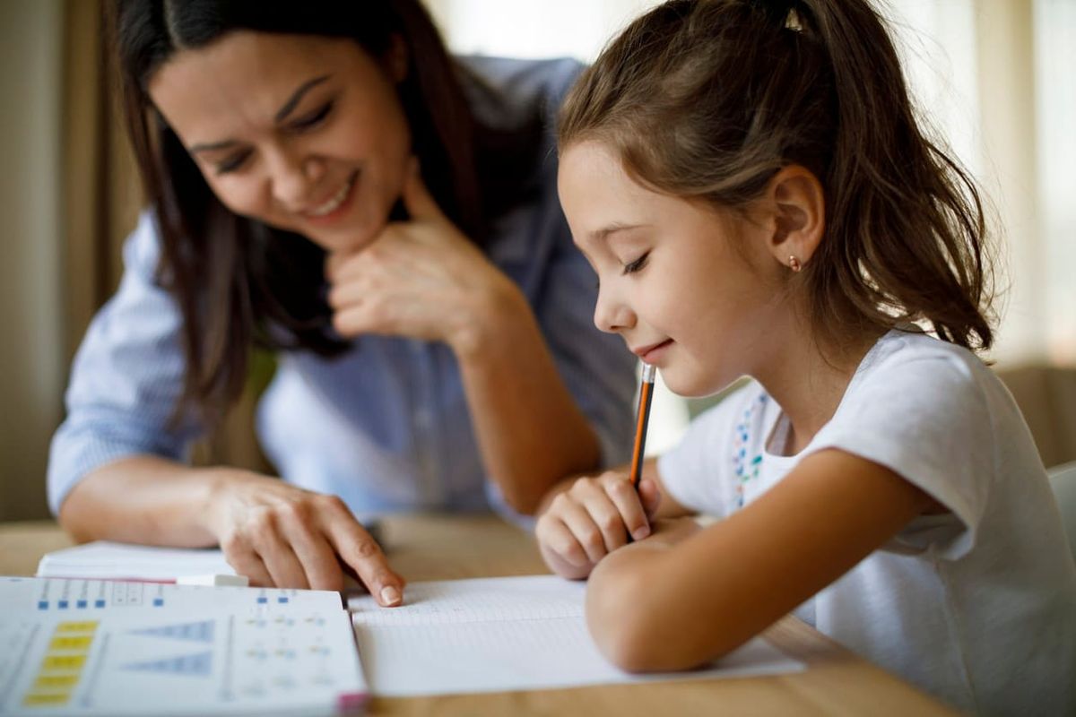 woman helping her kid - Alabama Homeschool Laws 